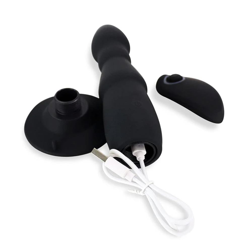 Ribbed black vibrating plug with a USB charging port and ergonomic remote control for custom patterns.
