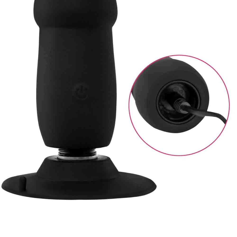 Body-safe black silicone expansion plug with deep concentric ribs and internal vibration motor.