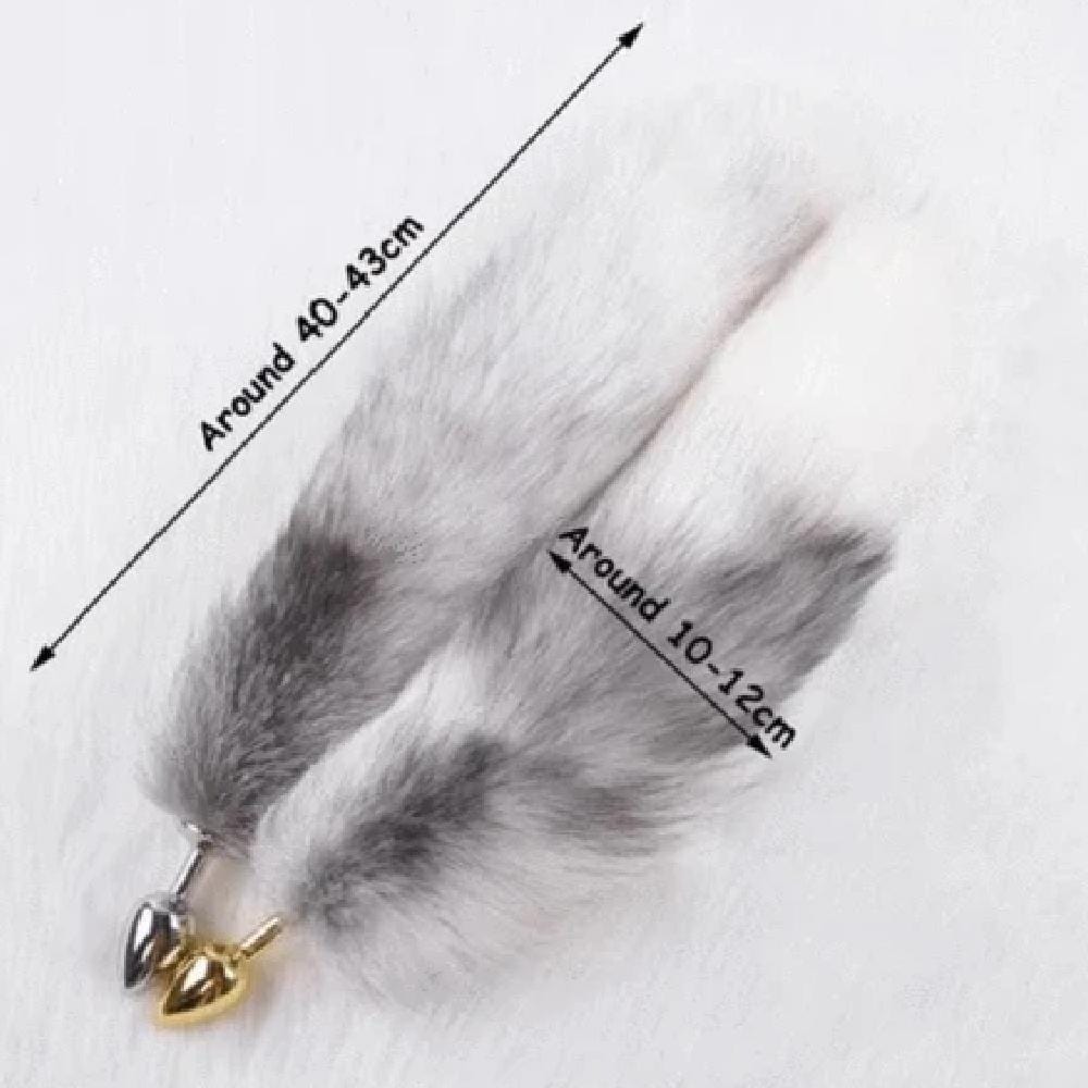 Take a look at an image of Elegant Fox Tail Plug 19 Inches Long in gold and silver colors, ready to inspire your deepest fantasies.
