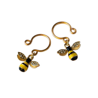 Feast your eyes on an image of Get Stung Clip on Nipple Piercing with bee charm adornments in black and yellow stripes, adding a playful touch to sensuality.