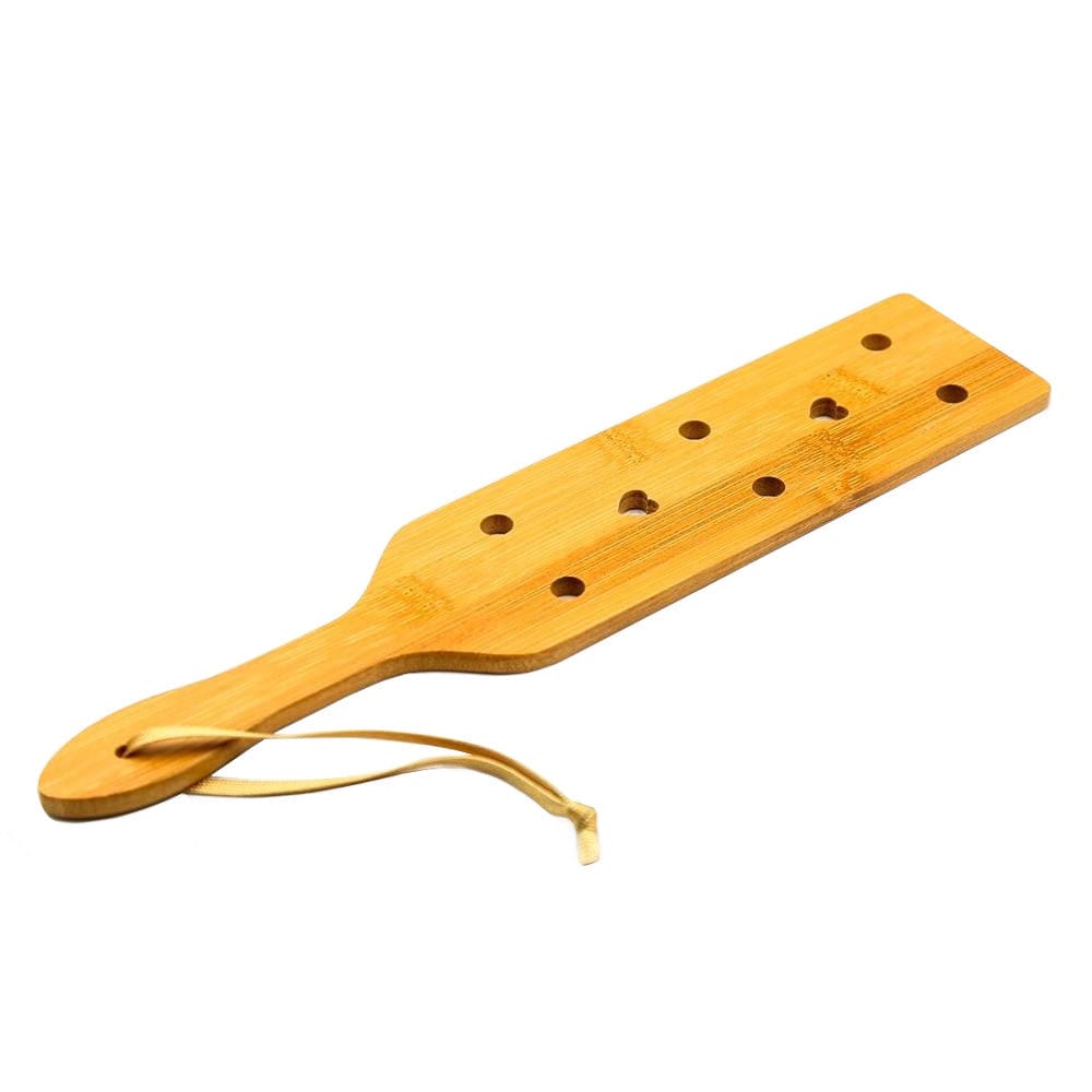 A BDSM paddle made from bamboo, perfect for beginners exploring the world of impact play.