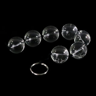 An image displaying the smooth, cool texture of Clear Orbs Glass Anal Balls for stimulating sensations.