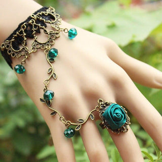 Observe an image of Floral Slave Ring Bracelets featuring a plant-shaped lace charm on a tin alloy chain.