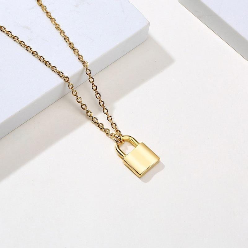 Pictured here is an image of Tiny Lock Chain Necklace, showcasing the fine details of the pendant size and link chain texture.