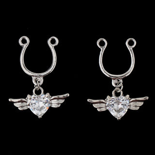 Displaying an image of Winged Gem Fake Nipple Piercings showcasing crystal-studded heart charm and stainless steel material.