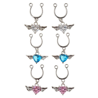 Observe an image of Winged Gem Fake Nipple Piercings with U-shaped shield and winged heart charm in clear, blue, and pink colors.