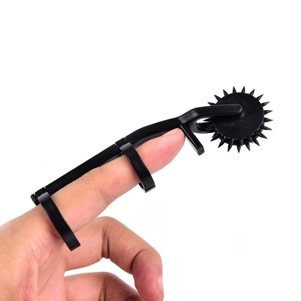 In the photograph, you can see an image of the compact and easy-to-hold Naughty Finger Wartenberg Pinwheel, perfect for personal use or sharing with a partner.