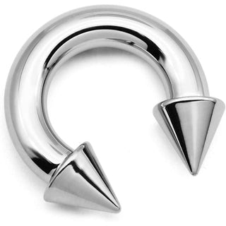 In the photograph, you can see an image of a variety of sizes of Hypoallergenic Prince Albert Piercing Body Jewelry with curved, horseshoe design and double-ended spikes for added texture