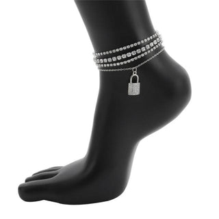 A Cuban link anklet with a lock charm encrusted with sparkling crystals for a bold fashion statement.